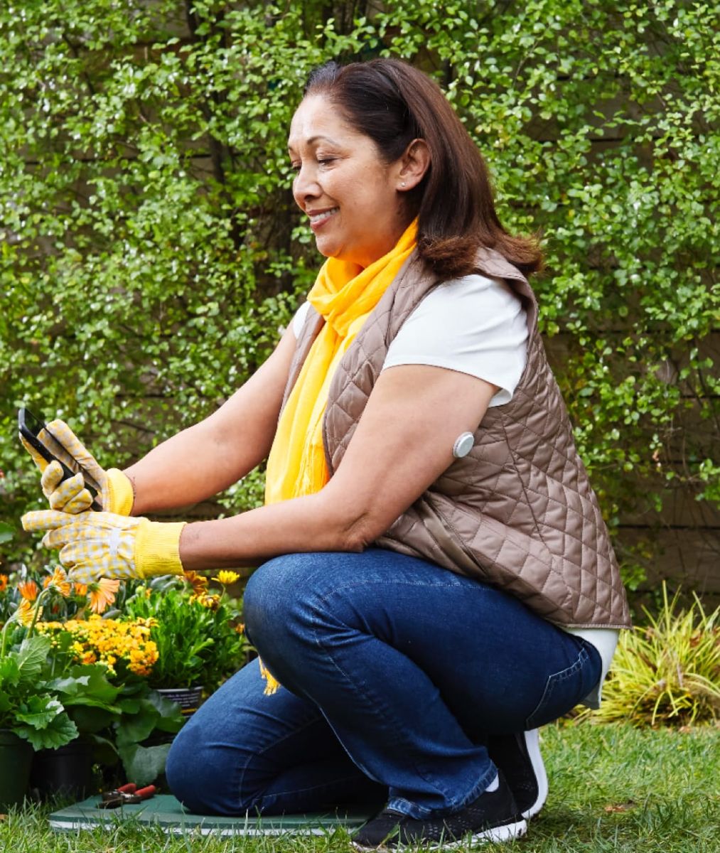 Woman checking glucose levels outside