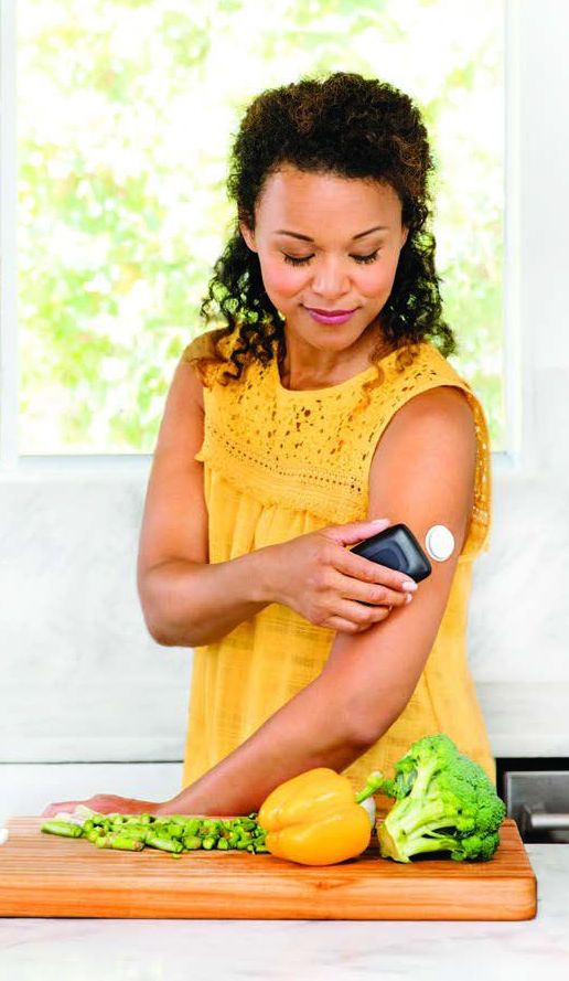 Woman checking glucose levels on CGM